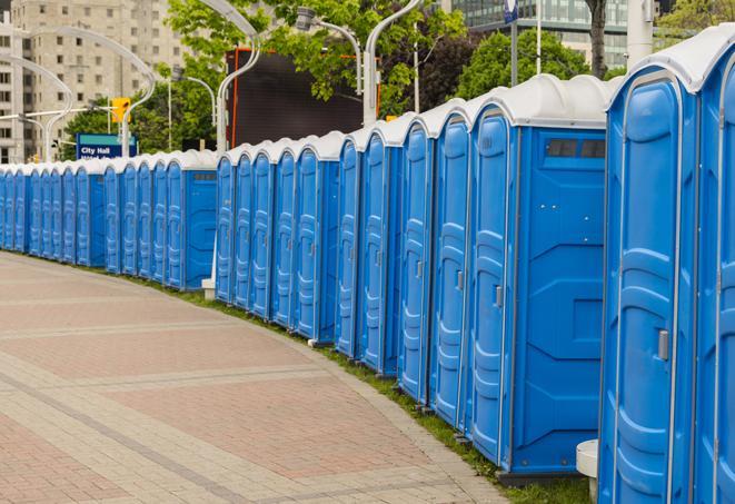 hygienic portable restrooms lined up at a beach party, ensuring guests have access to the necessary facilities while enjoying the sun and sand in Hobe Sound FL